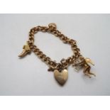 9ct Gold - A yellow metal charm bracelet, stamped 375 / 9, with 9ct gold padlock clasp,