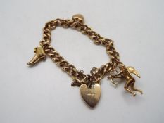 9ct Gold - A yellow metal charm bracelet, stamped 375 / 9, with 9ct gold padlock clasp,