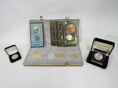 A collection of commemorative coins / medallions struck by Liberty Mint comprising Disney,