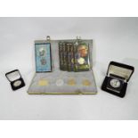 A collection of commemorative coins / medallions struck by Liberty Mint comprising Disney,