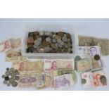 A collection of UK and foreign coins and banknotes, some silver content noted.