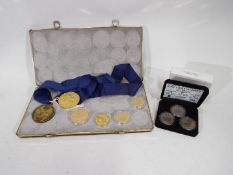 A collection of sporting related coins / medallions to include a 27 gram .