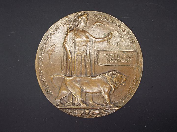 A World War One (WW1 / WWI) bronze memorial plaque to John Patrick McCormack.