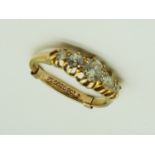 A lady's hallmarked 18 carat yellow gold ring set with five old brilliant cut diamonds estimated to