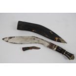 A vintage kukri knife with leather sheath.