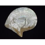 A Chinese mother of pearl shell carving depicting a battle scene with a background of buildings in