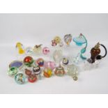 A varied collection of paperweights and glassware.