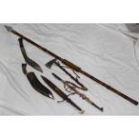 Various tribal style weaponry ornaments, a kukri knife,