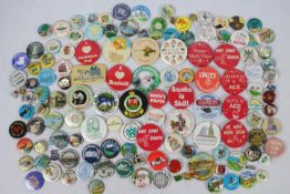 A collection of vintage pin badges, predominantly tourist destinations, towns,