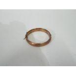 A 9ct rose gold hinged bangle, internal diameter 5.5 cm, approximately 10.