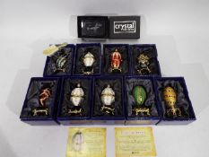 Nine boxed Atlas Editions Faberge style eggs and a paperweight.