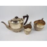 An Edwardian silver tea set comprising teapot, sugar bowl and milk jug,