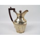 A Victorian silver jug with gadrooned decoration, London assay 1897,