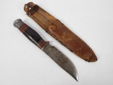 A vintage Wade & Butcher Boone hunting knife in later sheath.