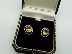 A pair of yellow Beryl and white Diamond earrings with white metal mounts stamped 18K (18 carat),