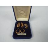 Three 9ct gold charms, two anchors and one heart,