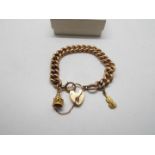 Gold - A rose metal bracelet, stamped 9c with a 15ct gold heart padlock clasp and two charms,
