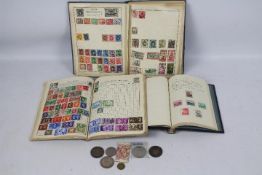 Philately - Three albums of world stamps and a small quantity of coins,