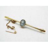 A mid-purity, stone set bar brooch with safety chain, stamped 15ct, approximately 4.1 grams.