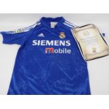 Real Madrid Football Club - A replica shirt bearing multiple signatures with certificate of