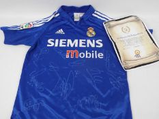 Real Madrid Football Club - A replica shirt bearing multiple signatures with certificate of