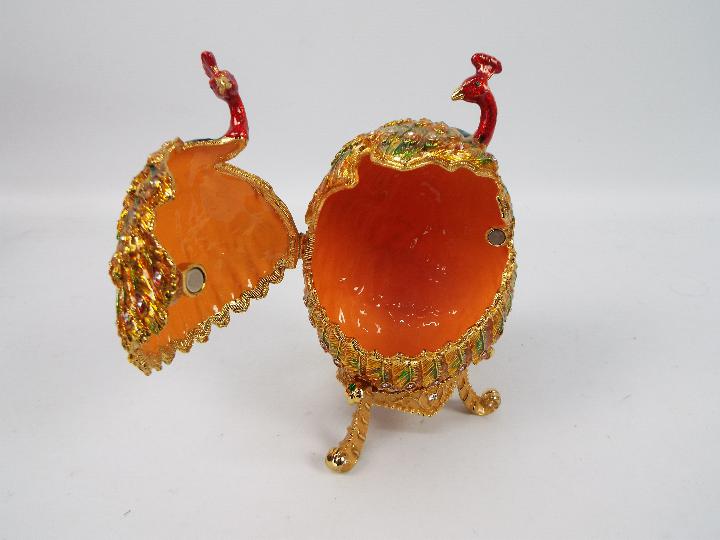 A large enamel and crystal encrusted trinket box of ovoid form depicting a pair of peacocks, - Image 3 of 5