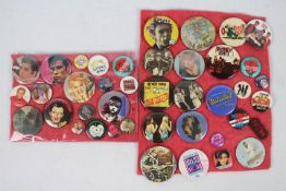 A collection of vintage pin badges relating to bands / musicians to include The Sex Pistols,