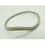 A lady's white metal bracelet stamped 18K (18 carat),