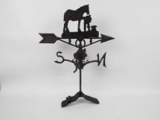 A cast iron weather vane with horse and