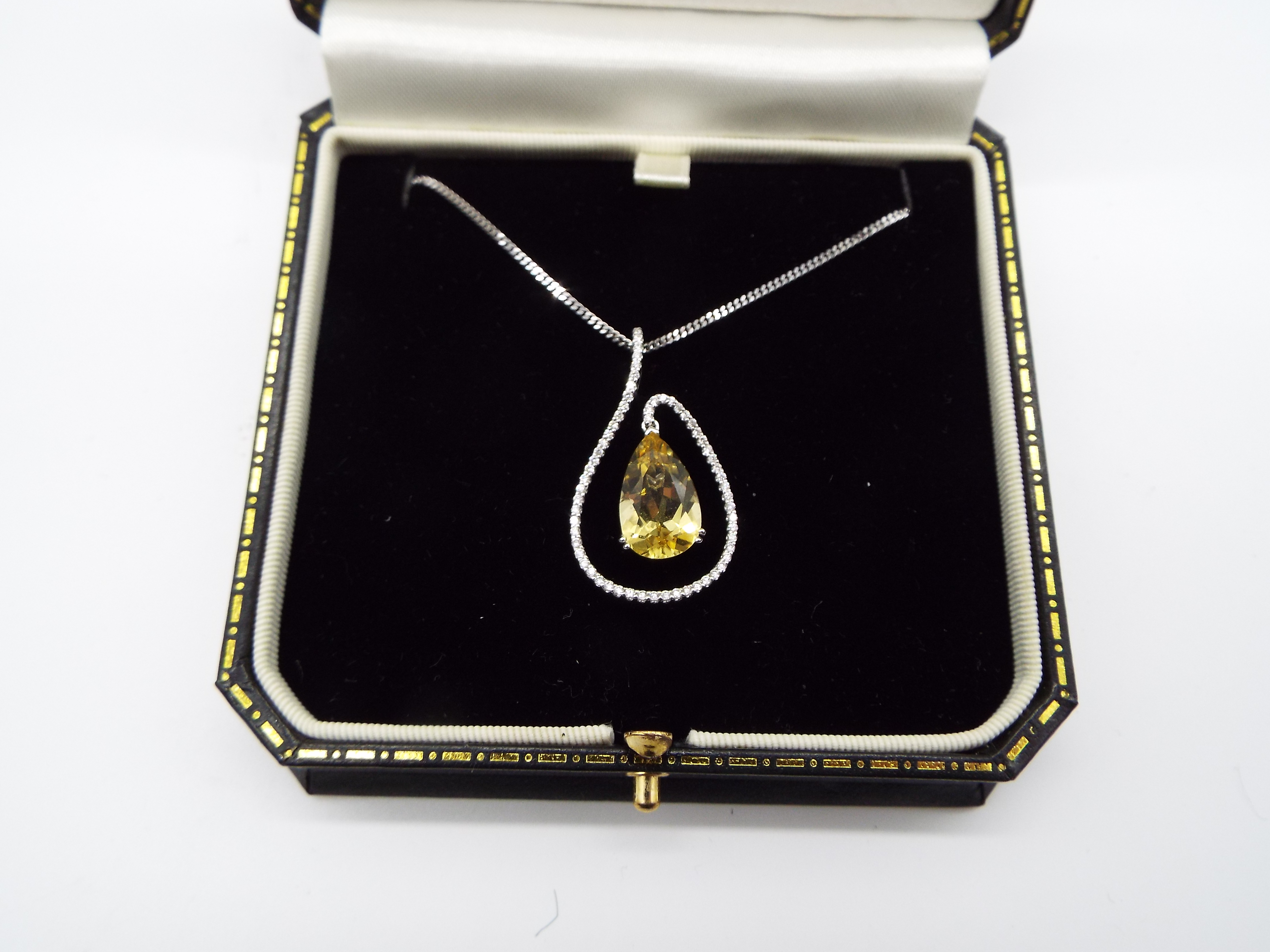 A yellow Beryl and white Diamond pendant