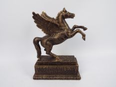 A bronzed cast iron model depicting Pega