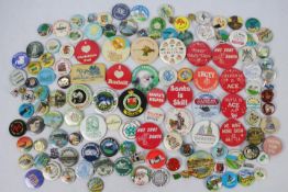 A collection of vintage pin badges, pred