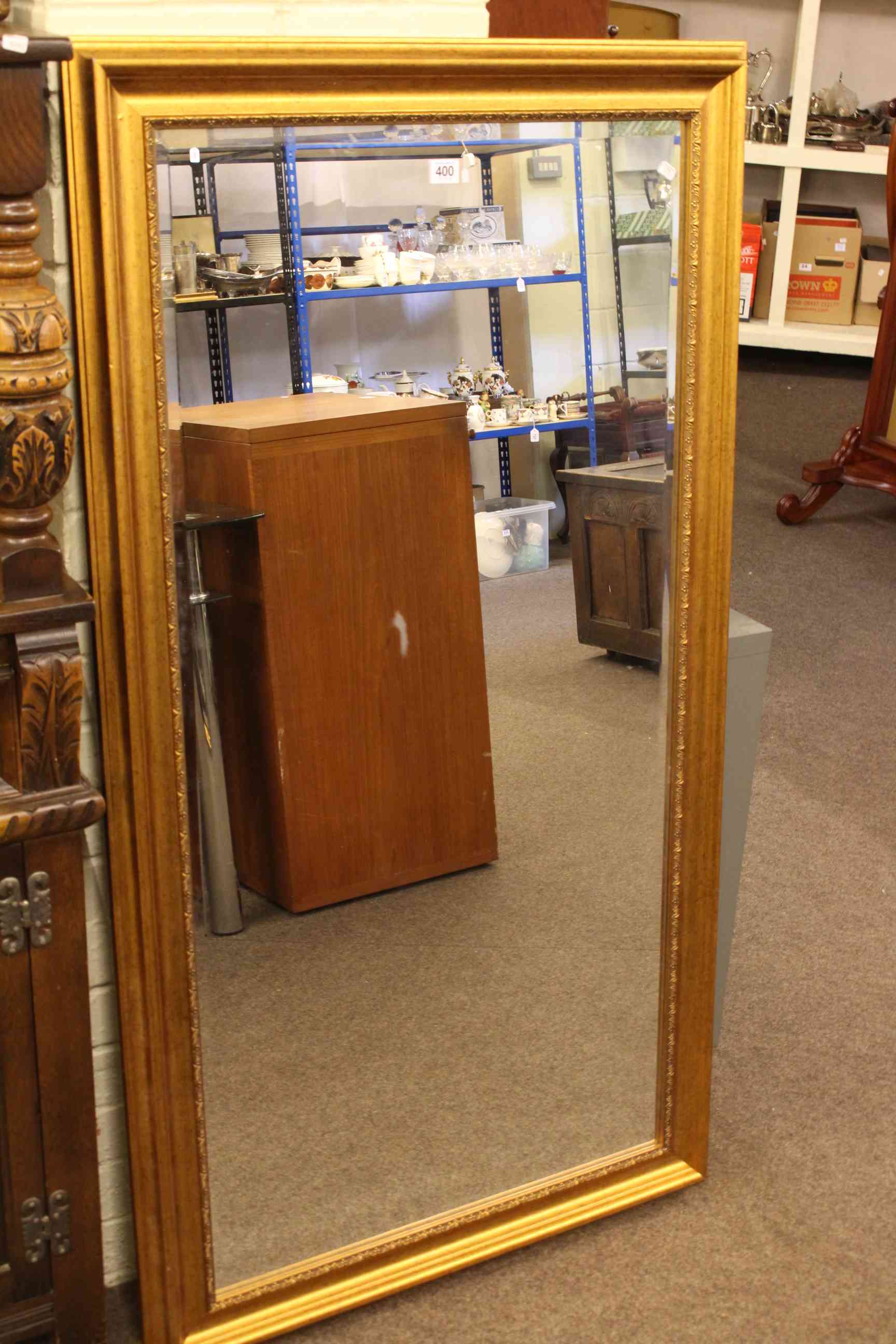 Gilt framed rectangular bevelled wall mirror, 136 x 75cm overall.