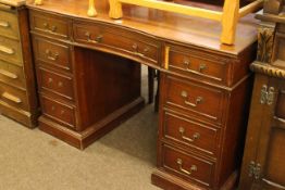 Mahogany inverted bow front nine drawer pedestal desk, 77cm by 117cm by 58.5cm.