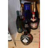 Seven bottles of assorted alcohol including two Martell Cognac, Laurent Perrier Champagne,