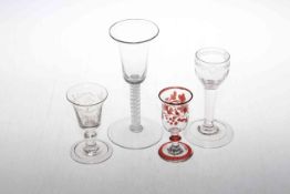 Four wine glasses including cotton twist stem glass, ruby overlaid glass and two etched glasses.