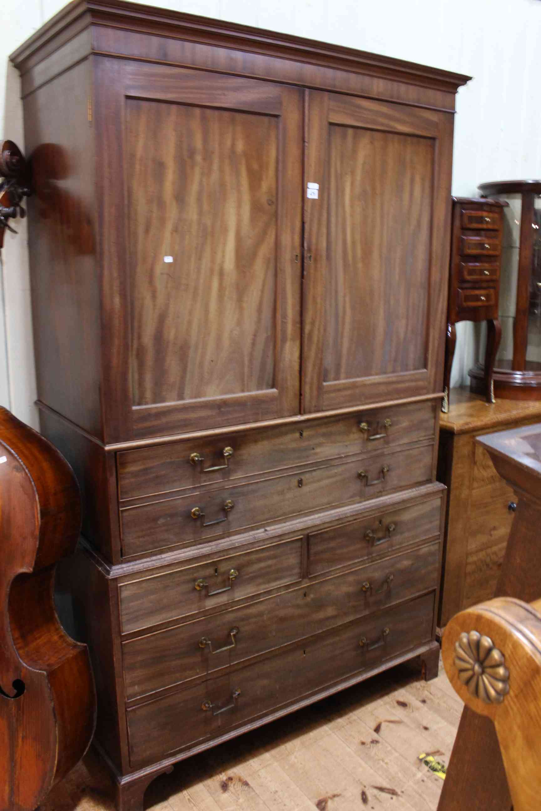 Victorian mahogany secretaire linen press having two panelled doors above a secretaire drawer with
