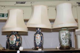 Three Oriental pottery table lamps with shades.