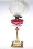 Victorian brass oil lamp with pink decorated glass reservoir and etched frosted glass shade.