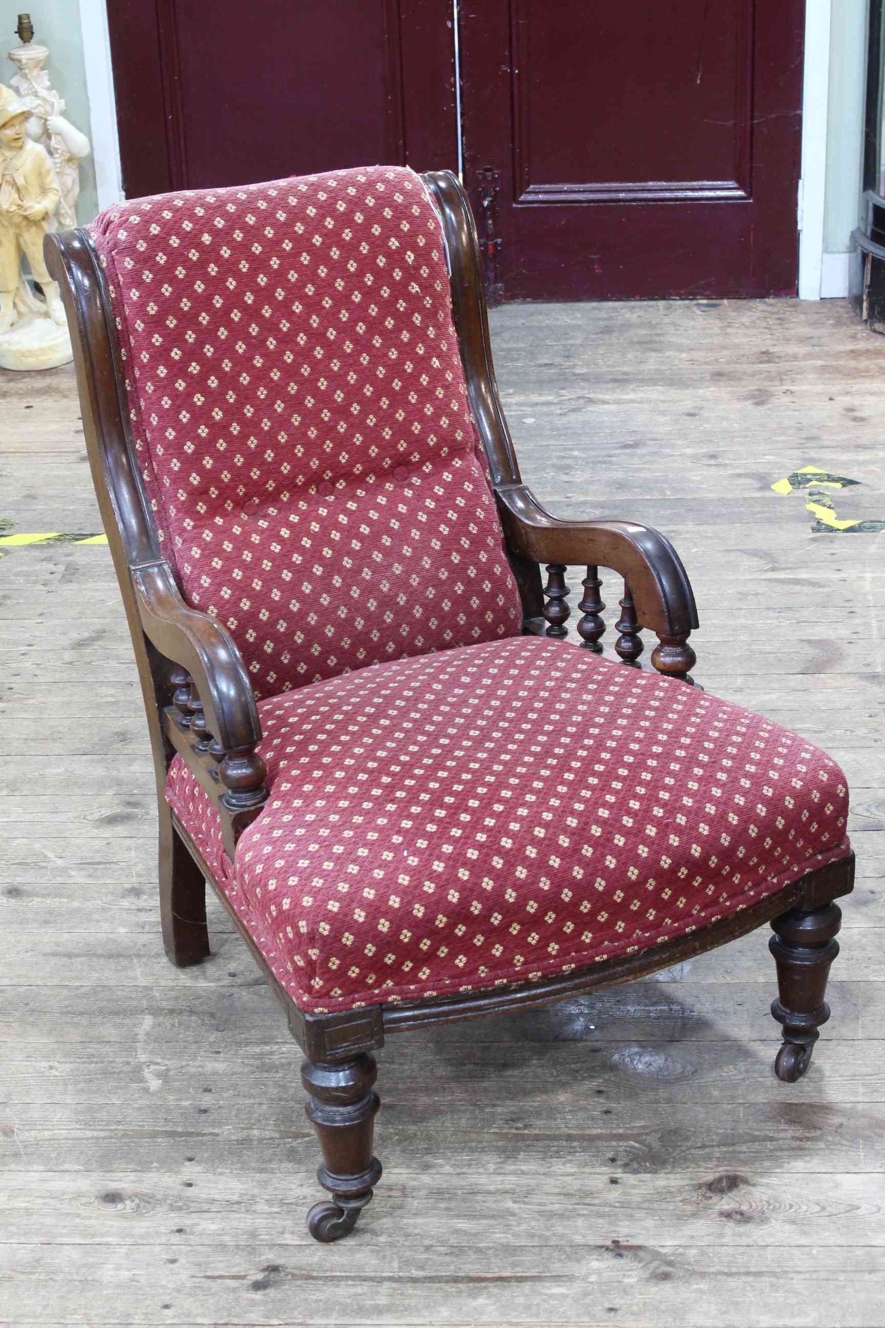 Victorian low armchair on turned legs.
