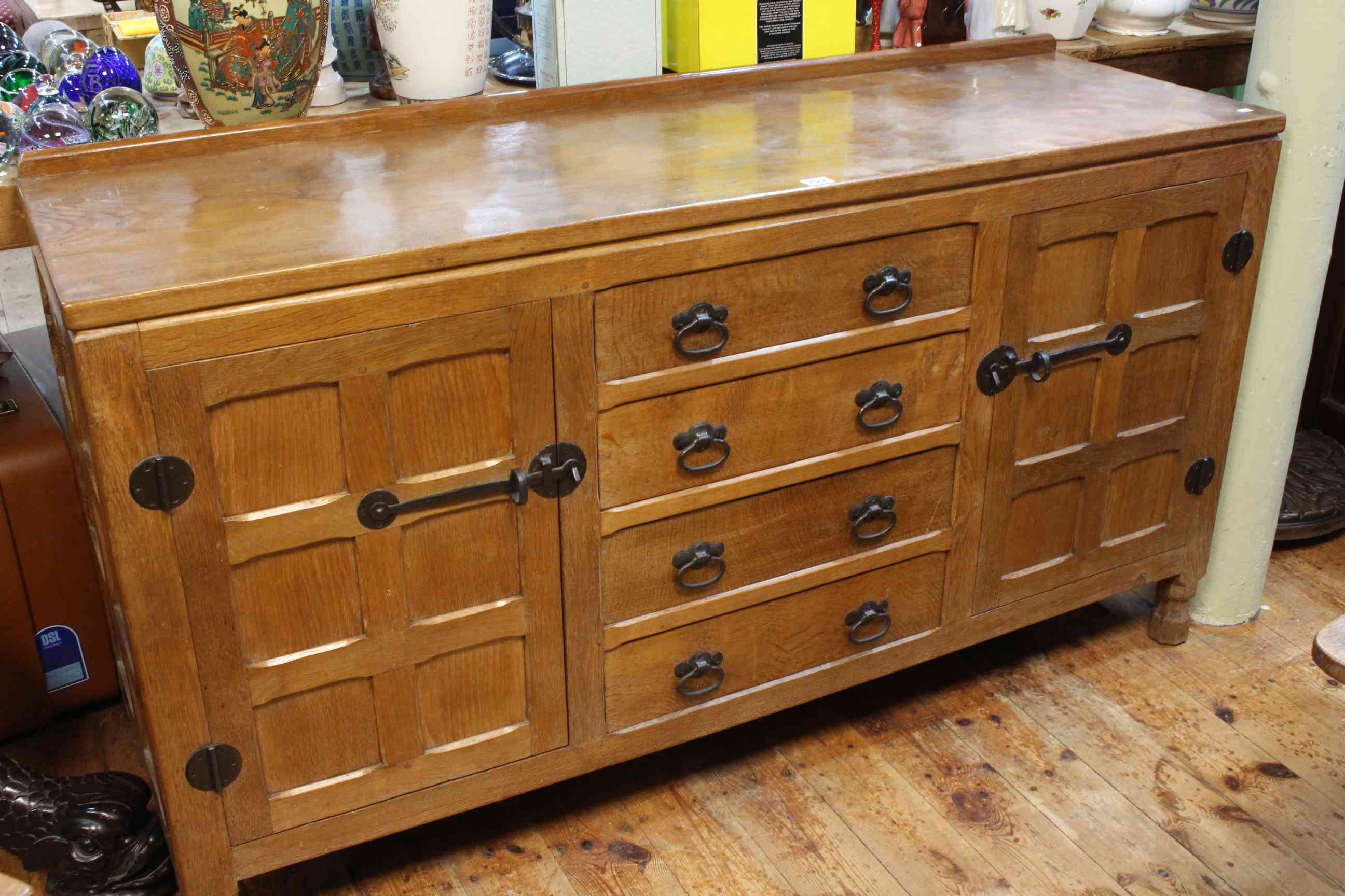 In the manner of Robert Thompson jointed oak and adzed cut sideboard having four central drawers