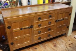 In the manner of Robert Thompson jointed oak and adzed cut sideboard having four central drawers