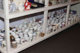 Full shelf of commemorative mugs and tins, etc.