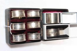 Cased set of six silver napkin rings and two others.