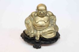 Bronze model of a seated Buddha on ebonised wood base.