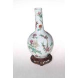 Chinese famille rose bottle neck vase on wood stand, red seal mark to base, 22cm.