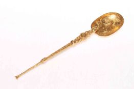 Silver gilt ornate anointing spoon with engraved and embossed decoration, London 1934.