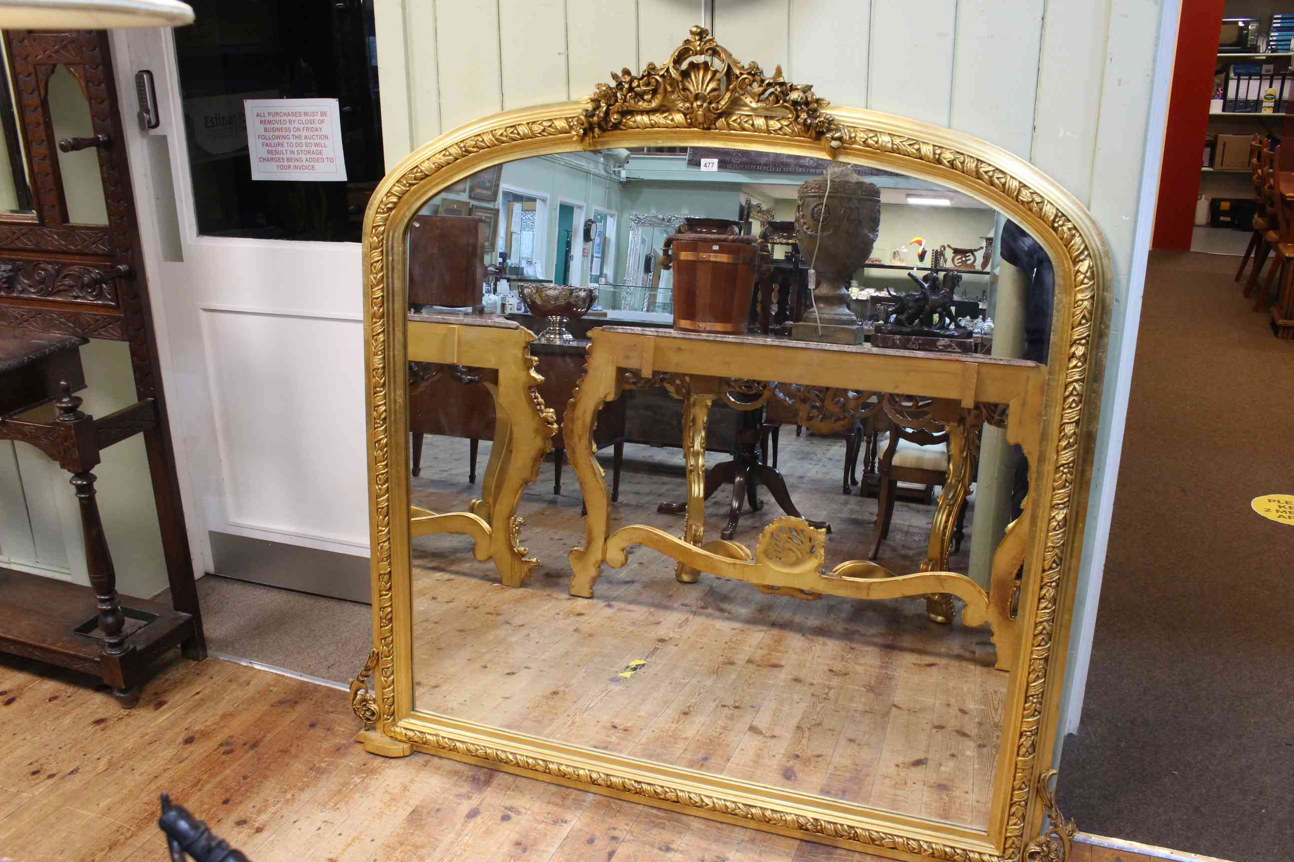 Gilt framed overmantel mirror with floral and swag crest, 159 x 160cm.