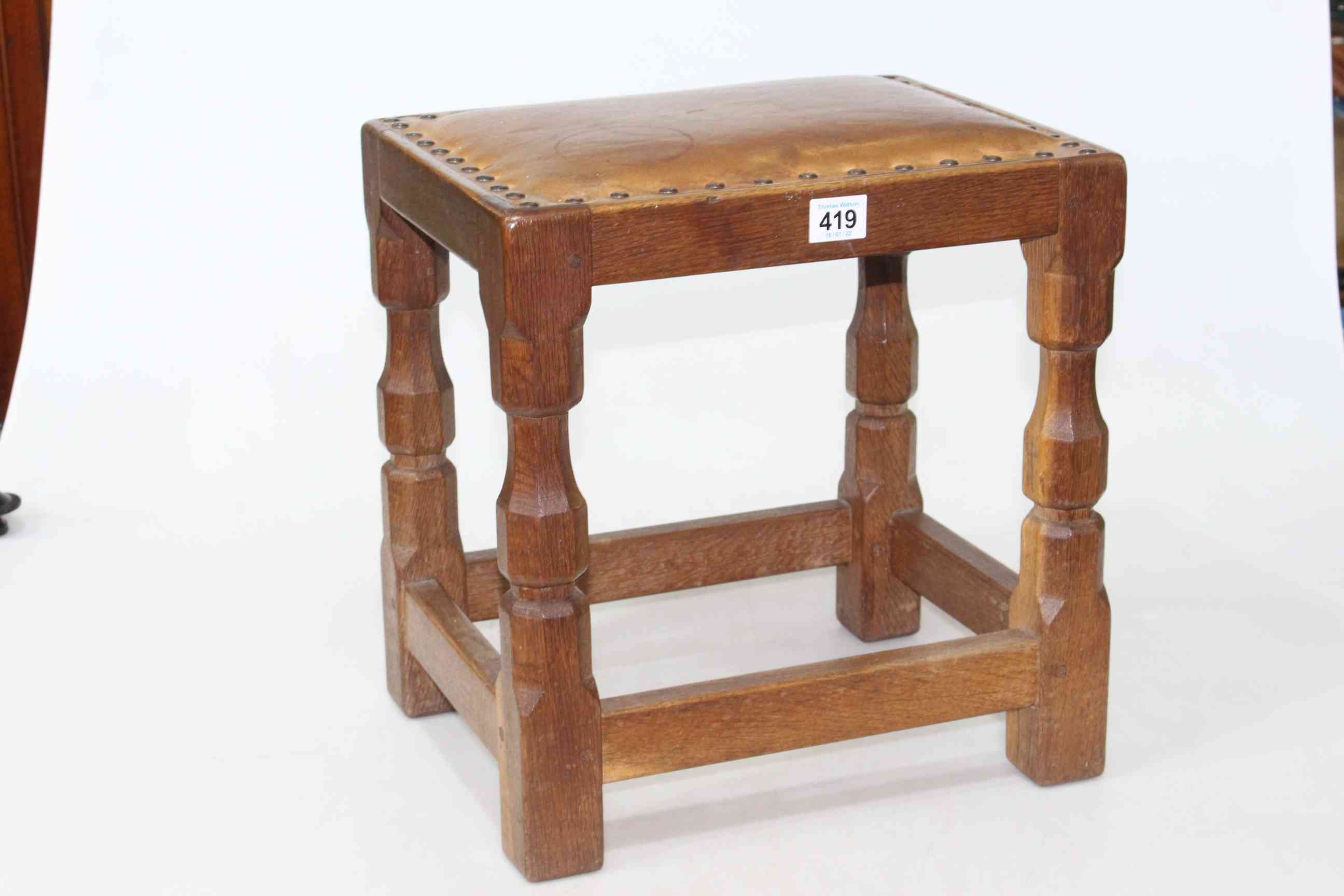 In the manner of Robert Thompson jointed oak and adzed cut stool with studded hide top,
