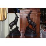 Pair of large bronze stags each on rocky outcrop mounted on marble bases, 76cm.